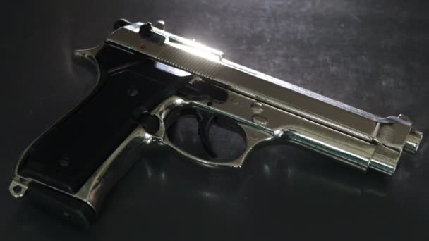 Silver 9Mm Pistol Lying Black Table Close — Stockvideo