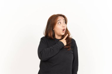 Beyaz arka planda siyah gömlekli güzel bir Asyalı kadını işaret ediyor.