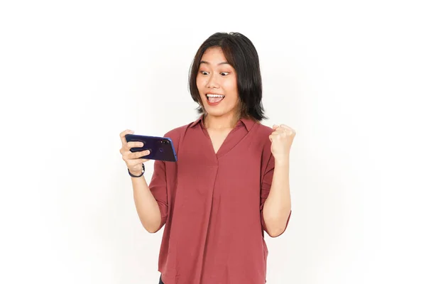 배경에 고립된 아름다운 아시아 여성의 스마트폰으로 게임을 — 스톡 사진