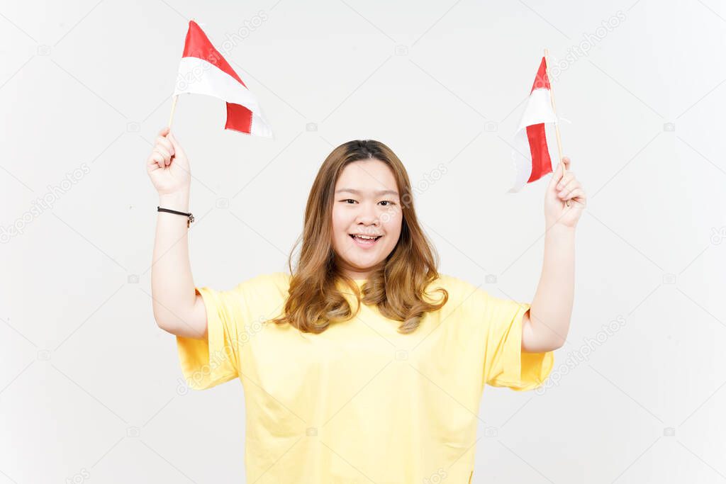 Holding Indonesian Flag, Independence of Indonesia of Beautiful Asian Woman wearing yellow T-Shirt