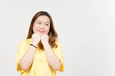 Smile and Thinking gesture of Beautiful Asian Woman wearing yellow T-Shirt Isolated On White