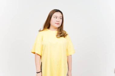 Looking aside of Beautiful Asian Woman wearing yellow T-Shirt Isolated On White Background