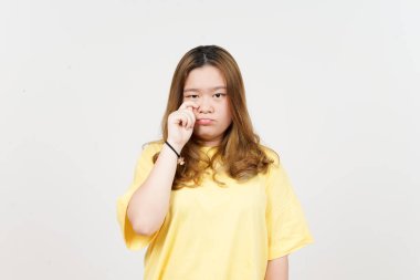 Sad Crying Face Expression of Beautiful Asian Woman wearing yellow T-Shirt Isolated On White
