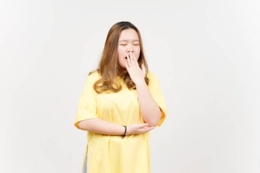 Yawning Gesture of Beautiful Asian Woman wearing yellow T-Shirt Isolated On White Background