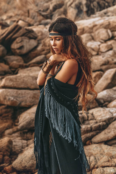 beautiful young stylish woman posing at sunset