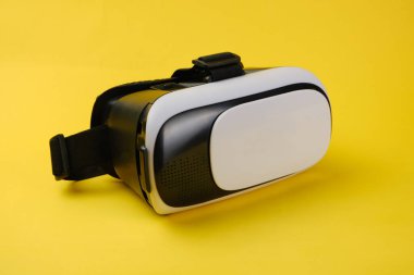 VR glasses isolated on yellow background.