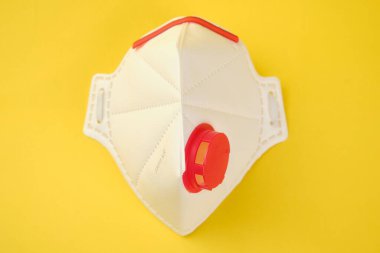 FFP3 class filtering mask respirator isolated on yellow background.