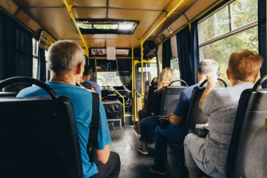 Odessa, Ukraine - August 3, 2022: Passengers in the cabin of the city bus.