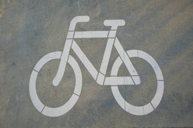 Ukraine, Odesa - August 11, 2022: Bicycle pictogram on concrete pavement. Cycling sign.