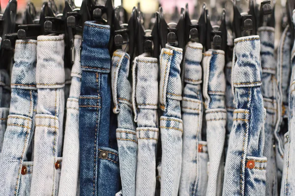 Jeans on a hanger in a clothing store. Close-up, selective focus.