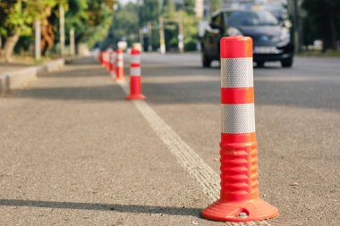 Anti-parking traffic cones on a bicycle path. Close-up, selective focus.