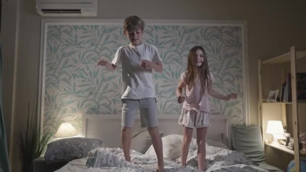 Cute smiling children having fun in bedroom. — Stock Video