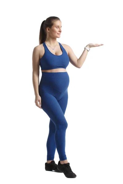 Χαριτωμένη Έγκυος Γυναίκα Μπλε Αθλητικά Στέκεται Πλήρη Ανάπτυξη Και Δείχνει — Φωτογραφία Αρχείου