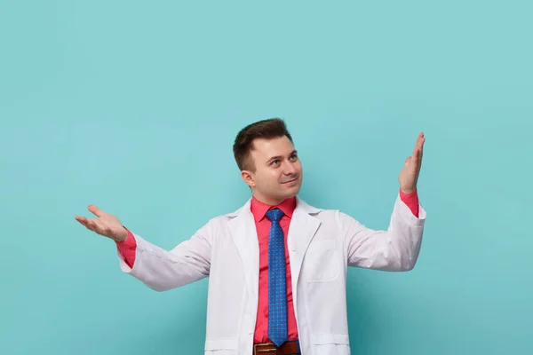 Young Surprised Male Doctor White Coat Makes Helpless Gesture Isolated — Stock fotografie