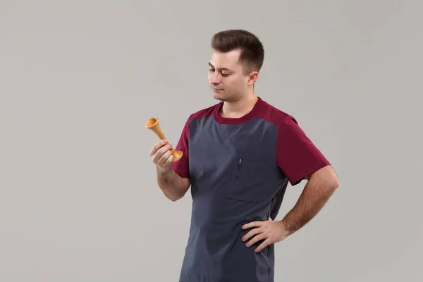 Young Doctor Gynecologist Surgical Suit Looks Carefully Wooden Stethoscope Isolated — Stockfoto