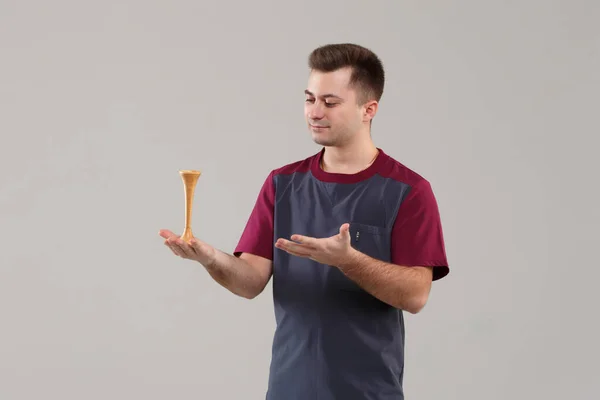 Young Doctor Gynecologist Surgical Suit Demonstrates Wooden Stethoscope Isolated Gray — Fotografia de Stock