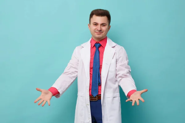 Young Doctor White Coat Makes Helpless Gesture Isolated Blue Background — Stock Photo, Image