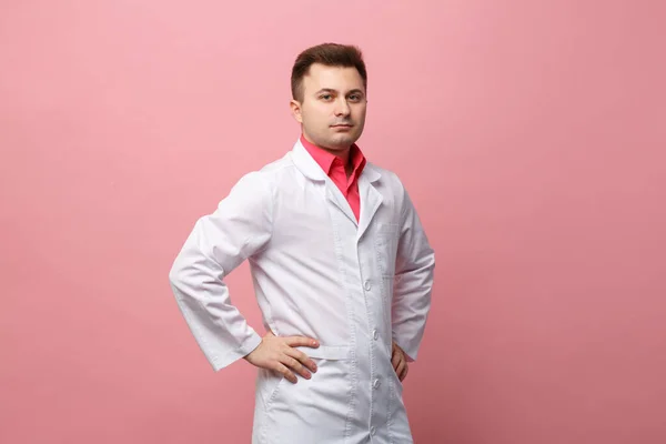 Young Serious Doctor White Coat Pink Background — Foto de Stock