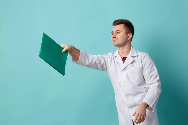 Young Doctor Green Folder Hands Isolated Blue Background — Stock Fotó