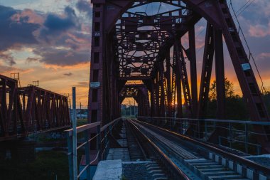 View of big steel railway bridge on sunrise.