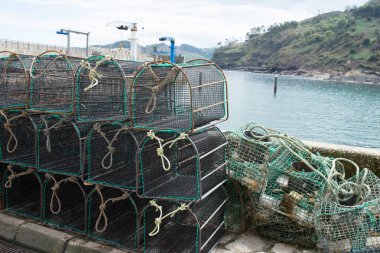 Boş kafesler ve ağlar yığını. Tazones rıhtımı, Asturias, İspanya