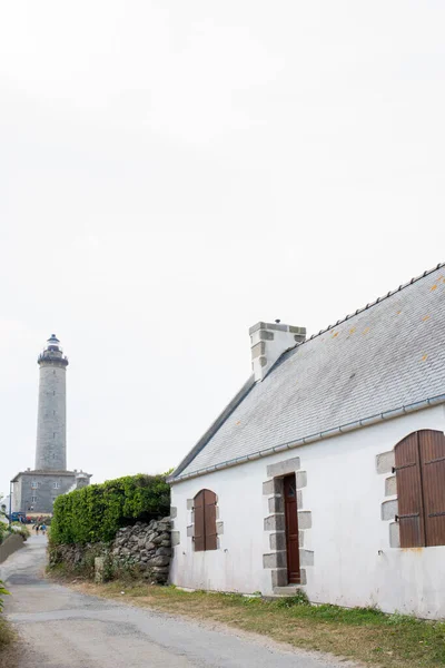 Batz island. Traditional architecture and lighthouse in the distance. Brittany