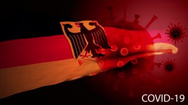 COVID-19 sürekli dalgalanan bir bayrağın arka planında dönmeye devam ediyor.