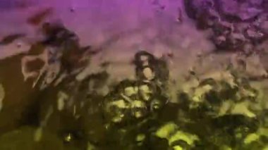 Renkli su yukarıdan sürekli akar, parlak görünür..