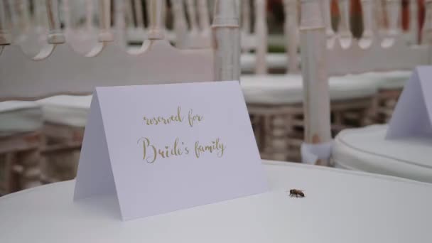 Sign on a chair with the name of the brides family — Video