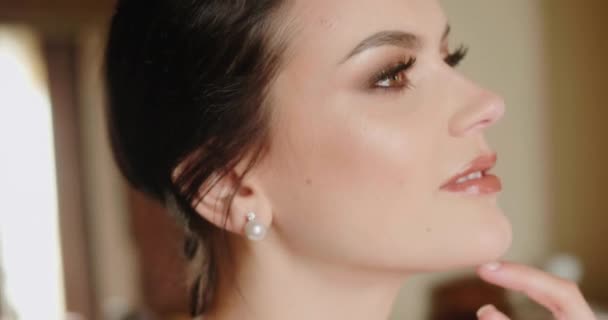 Bride touches neck with hand smiling and looking in camera — Stock Video