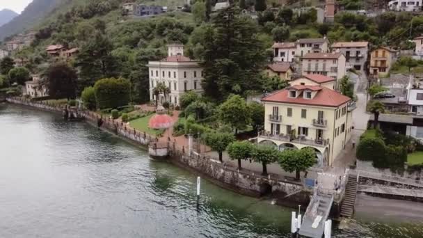 Aerial drone footage of small city on lake Como. Lombardy, Italy. — Stock Video