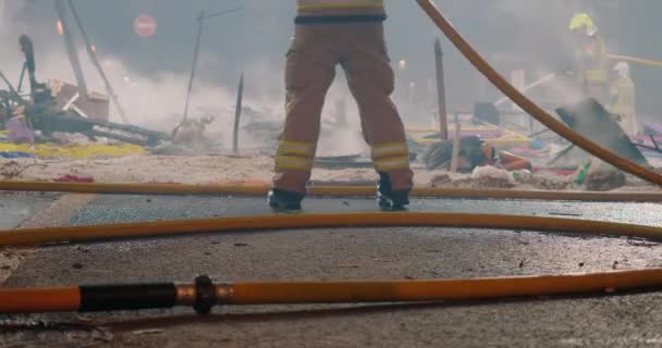 Firefighters put out fire remaining from burning figures — Vídeo de stock