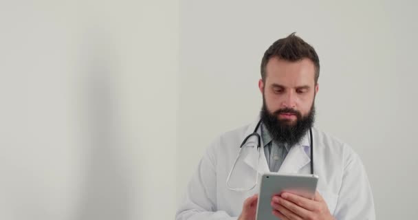Erkek Doktor Klinikte Tablet Üzerinde Çalışıyor Sakallı Terapist Internet Üzerinden — Stok video