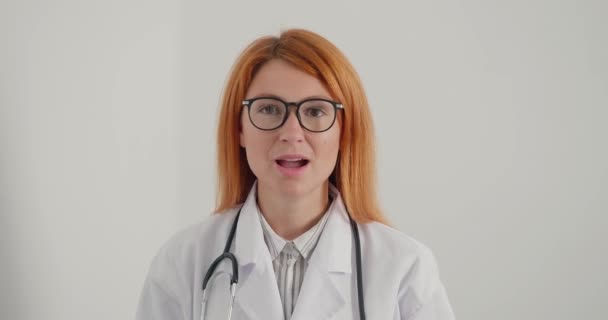 Ärztin Mit Brille Und Ingwerhaar Lächelt Und Gibt Vor Laufender — Stockvideo