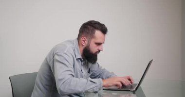 Klavyede hata yapan sinirli bir adam hızlı yazar. Uzun sakallı kızgın serbest çalışan, odadaki masada oturan elektronik cihaza isabet etti.