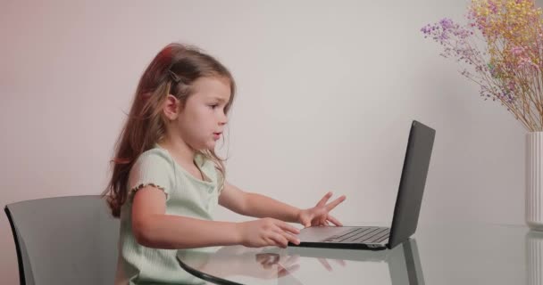 Diligent Bored Schoolgirl Sits Desk Communicating Teacher Video Conference Laptop — Stock Video