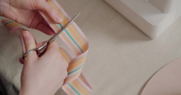 Woman Cuts Wide Colorful Ribbon Scissors Sitting White Table Skillful — Video Stock