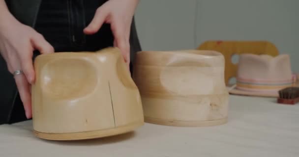 Woman Checks Wooden Molds Creating Handmade Hats Standing White Table — стокове відео