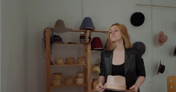 Satisfied Blonde Woman Holds Finished Felt Hat Workshop Professional Milliner — Stockvideo