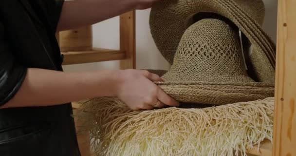 Woman Takes Wicker Straw Hats Standing Wooden Shelf Professional Milliner — Stock Video