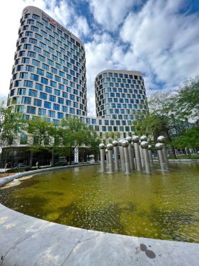 Brussels , Brabant, Belgium 09 18 2022 : Vertical closeup on the new modern Belgian Beobank head-office, Quator complex , downtown Brussels, against a before laying water fountain