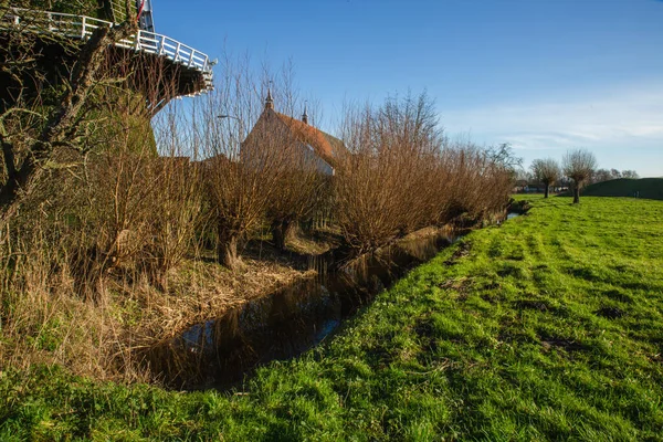 オランダのブラバント州のピットレスク風景 冬の風車 家と緑のフィールドと田舎の特徴的な景色 — ストック写真