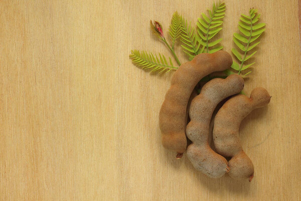 The tamarind on the wooden floor background