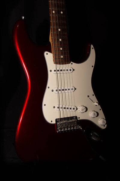 Close up shot of electric guitar on black background
