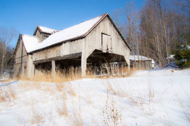 Farm barn in village during winter