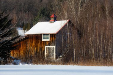 Farm barn in village during winter
