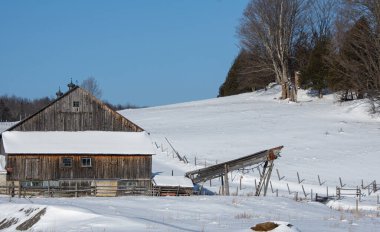 Farm barn in village during winter