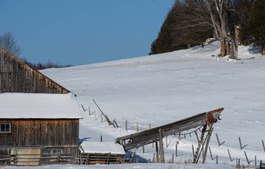 Farm barn in village during winter