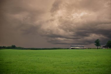 Canadian farm under stormy and threatening skies in the province of Quebec