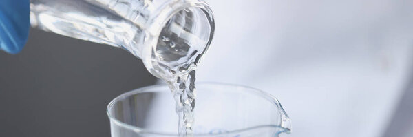 Scientist examines drinking water in laboratory closeup